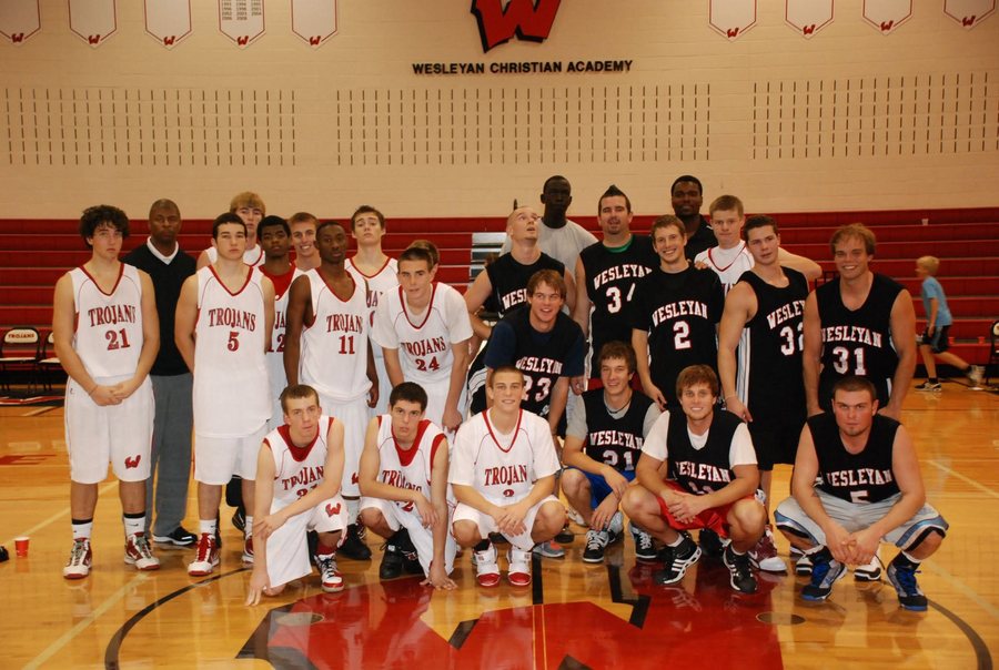 Basketball group posing together in the Wesleyan Christian Academy gym.